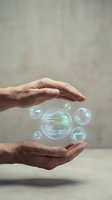 Male hands cradling glowing digital spheres with data code, representing technology protection, cybersecurity, and innovation for business solutions.