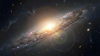 Spectacular spiral galaxy with bright central core and detailed spiral arms against deep space background with distant stars and cosmic dust clouds.