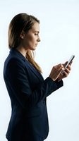 Young woman, Caucasian ethnicity, business professional wearing navy blazer, holding smartphone and looking at screen against white background for corporate communications.
