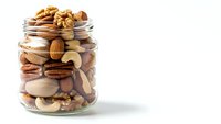 Mixed nuts and dried fruits in glass jar on white background for healthy snacking and cooking ingredients.