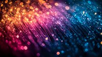 Vibrant fiber optic lights creating abstract bokeh effect with gradient from warm orange to cool blue tones against dark background, modern tech concept.