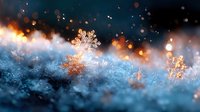 Delicate snowflakes glowing with golden light against dark blue winter background, magical frost crystals with bokeh effect creating dreamy seasonal atmosphere.