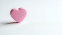 Pink heart shape on white background with soft shadow. Minimalist love symbol for romantic designs, Valentine's Day projects, and greeting cards.