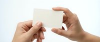 Two hands holding blank white card on clean background for business presentation mockup design template.