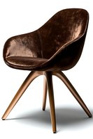 Modern brown velvet armchair with wooden legs on white background, featuring curved shell design and luxurious upholstery, suitable for interior design projects.