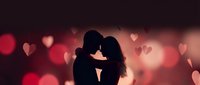 Romantic couple silhouette embracing against warm bokeh heart background for Valentine's Day, love, dating and relationship concepts.