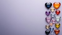 Colorful glass heart shapes arranged on purple background with copy space. Romantic crystal decorative elements in various colors and sizes create elegant composition.
