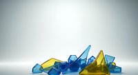 Colorful translucent glass shards and crystals in blue and yellow tones scattered on white surface, suitable for abstract backgrounds and design projects.