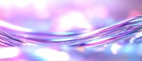 Flowing liquid waves in vibrant purple and blue colors create dynamic motion against blurred bokeh background, abstract macro photography composition.
