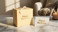 Elegant gold birthday gift box with ribbon and greeting card on marble table, warm candlelight, cozy home interior background.