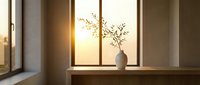 Minimalist interior with ceramic vase and dried branch on wooden shelf by large window during golden hour sunset creating warm atmospheric lighting.