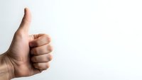 Hand showing thumbs up gesture on white background isolated for positive feedback and approval concepts.