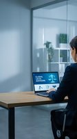 Professional woman using laptop with legal advisors interface in modern office workspace for business consulting and legal services.