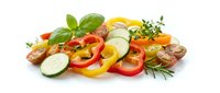 Fresh colorful vegetable medley with bell peppers, zucchini, tomatoes and herbs isolated on white background for healthy cooking and meal preparation.