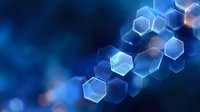 Glowing blue hexagonal shapes forming abstract technological pattern on dark background with bokeh effect and selective focus for modern tech designs.
