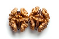 Fresh walnut kernels halves showing intricate natural patterns and texture on white background, macro food photography for healthy eating concepts.