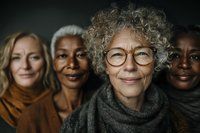 Diverse group of mature women with different ethnicities and hairstyles smiling at camera, representing beauty, wisdom and confidence in aging.