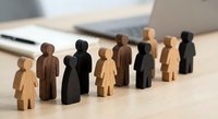 Diverse wooden human figures in row representing teamwork, inclusion and equality concepts for business presentations and social awareness campaigns.