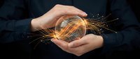 Hands holding glowing crystal ball with golden light sparks, symbolizing future vision, innovation, and business strategy for corporate and technology concepts.