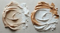 Creamy foundation makeup swirls in light and medium shades showing smooth texture and blendable coverage for cosmetic beauty applications.