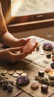 Woman practicing crystal healing meditation with amethyst and gemstones in warm sunlight for spiritual wellness and energy cleansing rituals.