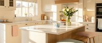 Modern kitchen interior with wooden island, white cabinets, marble countertops and natural lighting for home design and real estate marketing.