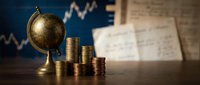 Global financial growth concept with vintage globe and golden coin stacks against rising market charts background for investment and economic analysis.