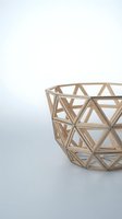 Modern geometric wooden basket with triangular lattice pattern on white background for home decor and storage solutions.