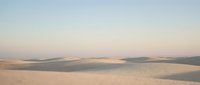 Desert landscape with rolling sand dunes under soft pastel sky at golden hour creating serene minimalist natural scenery for travel and nature content.