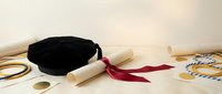 Graduation cap with diploma scroll tied with red ribbon on neutral background for academic achievement celebration and educational milestone ceremonies.
