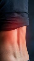 Close-up of toned male abdomen with defined muscles under dark athletic shirt, fitness and bodybuilding concept for health and wellness campaigns.