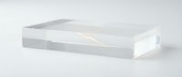 Clear acrylic display block or transparent plastic rectangular stand isolated on white background for product presentation and modern minimalist design.
