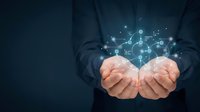 Business professional cupped hands presenting glowing digital network connections and data points against dark blue background for technology concepts.