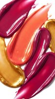Colorful lipstick smears in pink coral and gold tones on white background for cosmetic beauty and makeup advertising campaigns.