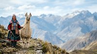 Young woman with indigenous South American heritage wearing traditional colorful textiles standing with llama in high altitude mountain landscape for travel and cultural content.