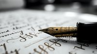 Vintage fountain pen nib with black handle resting on handwritten calligraphy text, suitable for writing, education, and artistic projects.