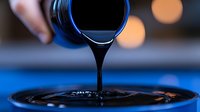 Dark viscous liquid pouring in slow motion creating ripple effect on surface with blue lighting and bokeh background, macro photography for cosmetic and spa products.