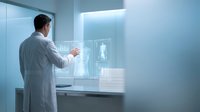 Male scientist in white lab coat analyzing transparent holographic display with medical data in modern laboratory environment for healthcare technology research.
