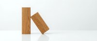 Two wooden blocks with natural wood grain texture positioned at angles against white background, isolated for design projects and creative layouts.
