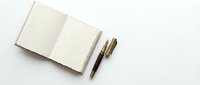 Open blank notebook with two pens on white background, suitable for business planning, journaling, writing, education, and creative projects.