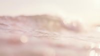 Soft pink ocean waves with dreamy bokeh lights creating peaceful seascape atmosphere for wellness and meditation backgrounds.