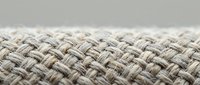 Close-up of woven beige fabric texture with interlocking threads creating a basket weave pattern, suitable for textile design and interior decor projects.