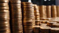 Golden copper coins stacked in tall columns creating wealth and savings concept for financial planning and investment growth strategies.