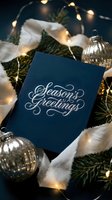 Elegant navy blue seasons greetings card with silver calligraphy, surrounded by pine branches, fairy lights, and mercury glass ornaments.