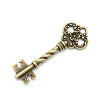 Ornate antique brass key with decorative floral scrollwork head and twisted shaft isolated on white background for vintage design projects.