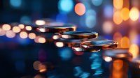 Stack of metallic coins with warm golden lighting and colorful bokeh background creating depth and financial investment atmosphere for business concepts.