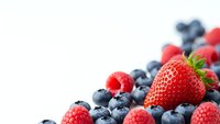 Fresh mixed berries including strawberry, blueberries and raspberries on white background. Healthy organic fruit for smoothies and desserts.