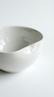 White ceramic mortar and pestle on clean background for kitchen cooking and food preparation needs.