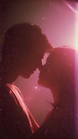 Silhouette of romantic couple about to kiss in cosmic space with pink nebula light and stars creating dreamy atmosphere for love and relationship concepts.