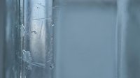 Close-up of cracked glass surface with spider web fracture pattern creating abstract texture background for design projects and artistic compositions.